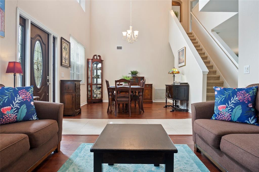 8746 Stone Harbour Loop Bradenton, FL 34212 - Photo 8 of 71 a living room with furniture a rug and a chandelier