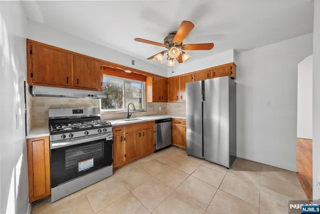 a kitchen with stainless steel appliances cabinets a sink and a stove