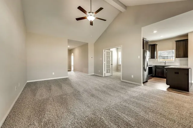 a view of a livingroom with a kitchen