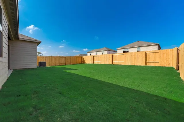 a view of an house with backyard space and garden