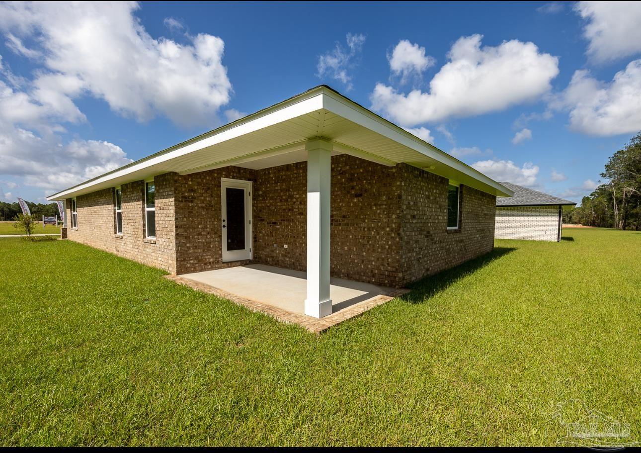 5303 Zenith Lane Milton, FL 32583 - Photo 3 of 16 a front view of a house with a yard