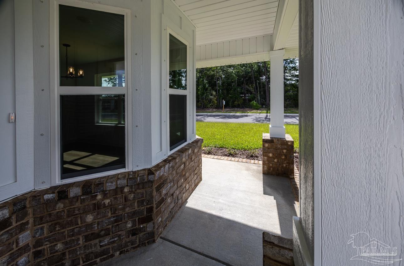 5303 Zenith Lane Milton, FL 32583 - Photo 5 of 16 a view of a room that has a bed and a view of balcony