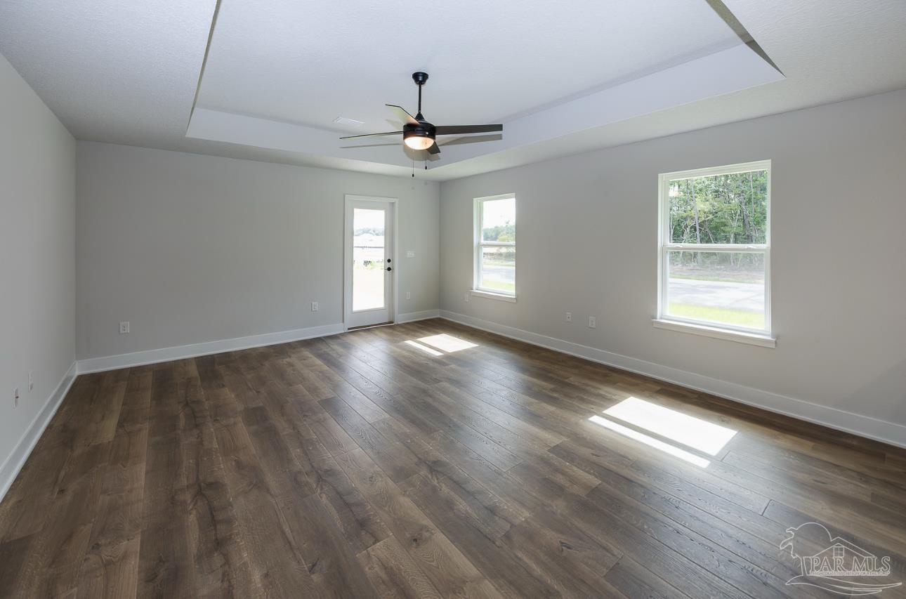5303 Zenith Lane Milton, FL 32583 - Photo 10 of 16 a view of an empty room with wooden floor and a window