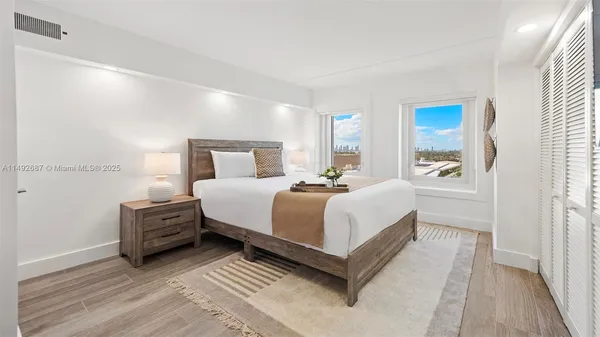 a bedroom with a bed and cabinets