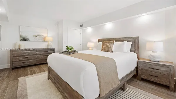 a bedroom with a bed and a night stand
