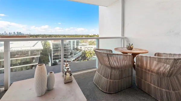 a view of a balcony with furniture and city view