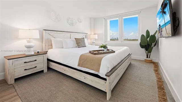 a bed room with a bed and a potted plant