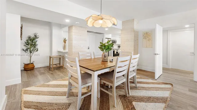 a dining room filled chandelier and fireplace