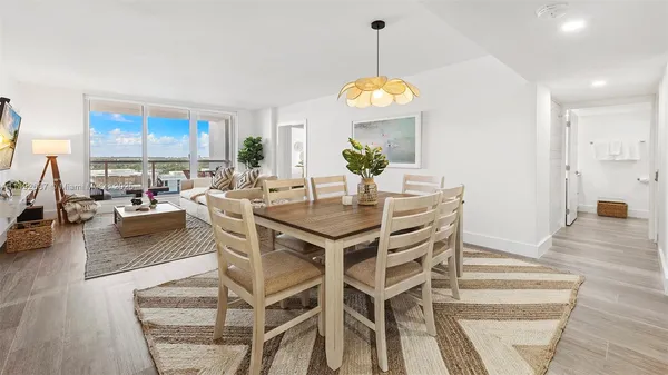 a view of a dining room with furniture wooden floor and a chandelier