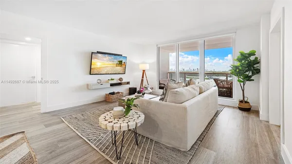 a living room with furniture and a flat screen tv