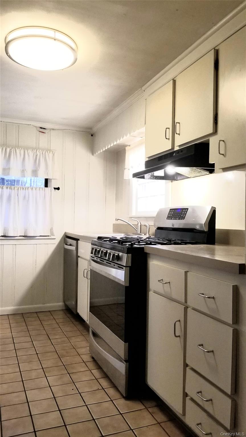 3 Rodman Place Spring Valley, NY 10977 - Photo 6 of 10 a kitchen with stainless steel appliances granite countertop a sink and a stove