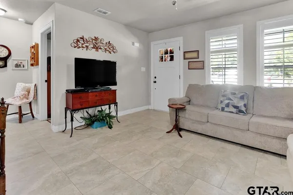a living room with furniture and a flat screen tv
