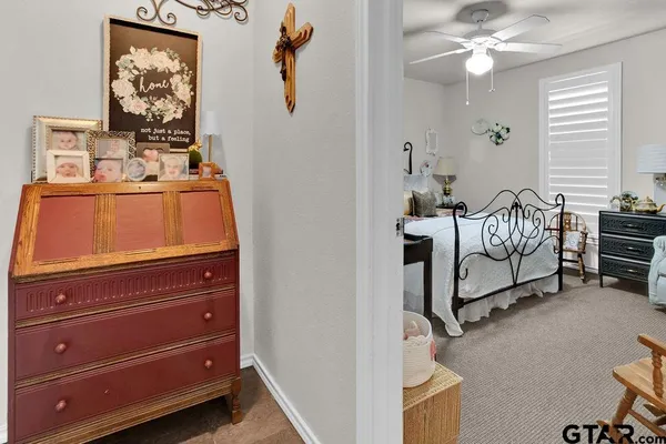 a spacious bedroom with a bed and painting on the wall
