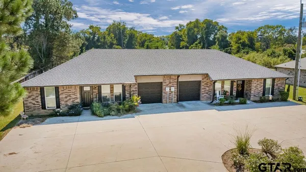 an aerial view of houses with yard