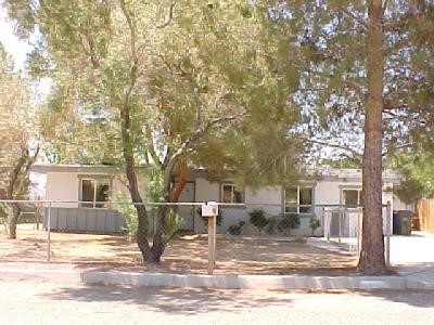 23967 Tocaloma Road Apple Valley, CA 92307 - Photo 1 of 1 a front view of a house with a tree