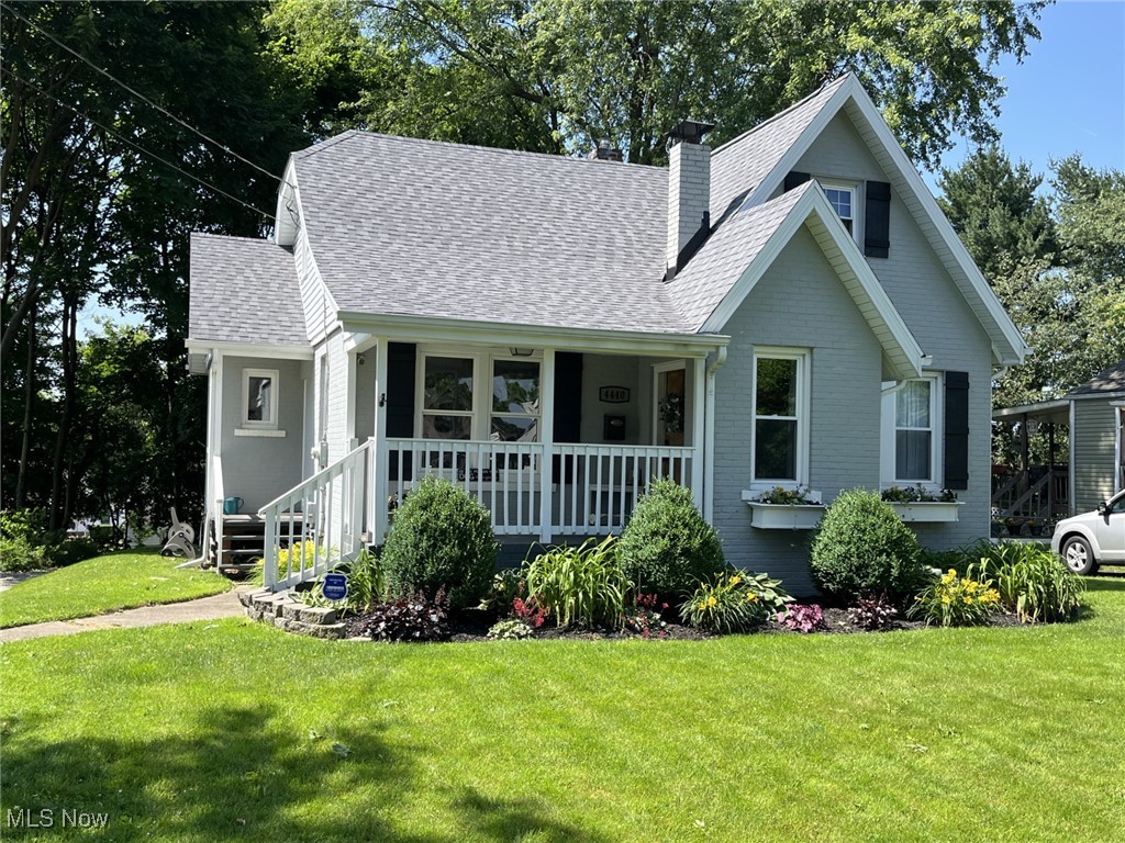 4440 Dryden Court Southwest Canton, OH 44708 - Photo 3 of 28 View of front of house featuring covered porch, a front lawn, roof with shingles, and a chimney