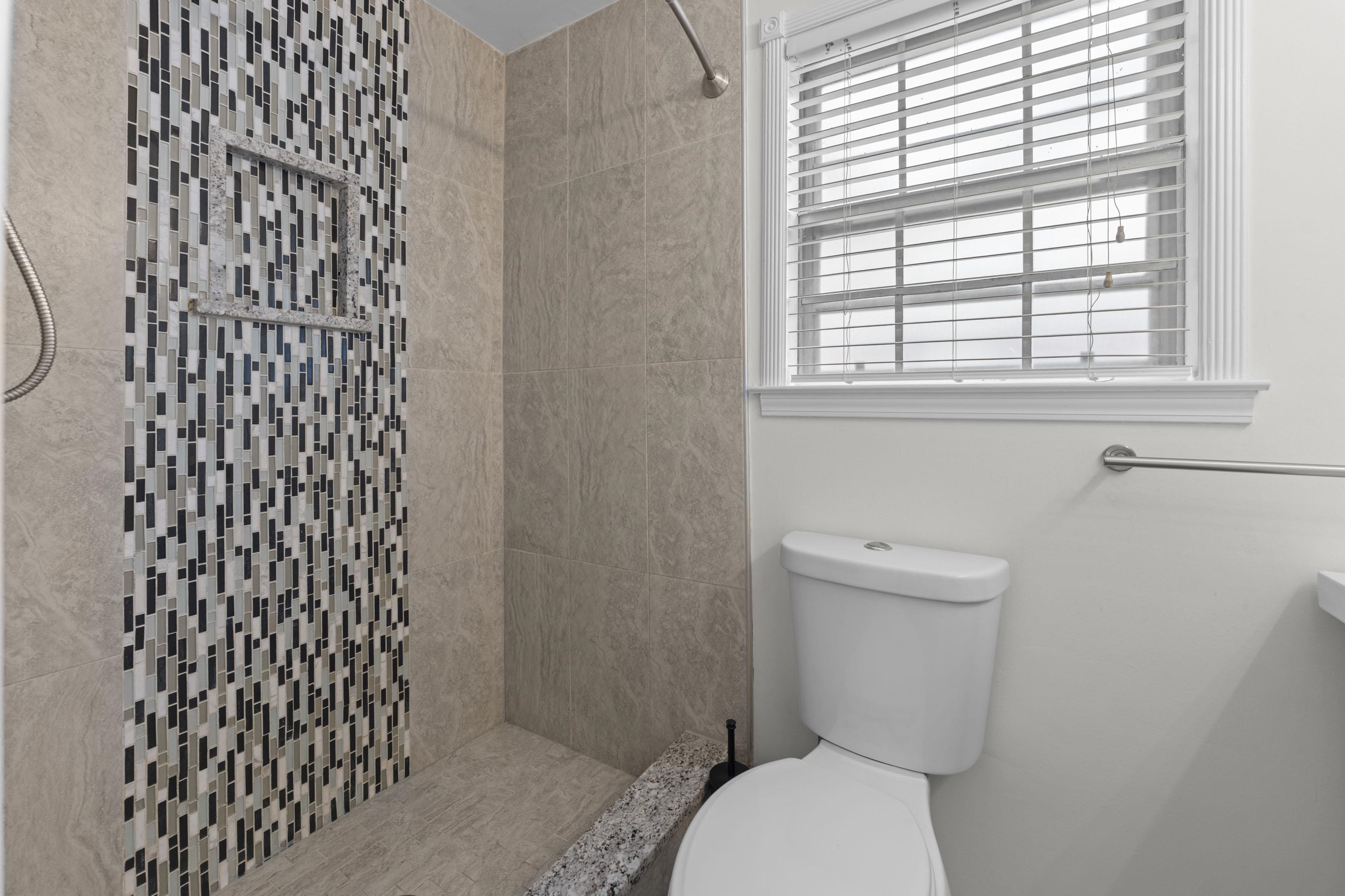 499 Duscoe Street Collierville, TN 38017 - Photo 10 of 38 a white toilet sitting next to a window in a bathroom