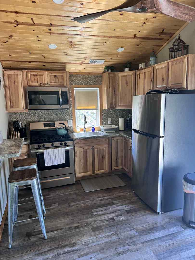 3347 East 2059th Road Ottawa, IL 61350 - Photo 3 of 8 a kitchen with stainless steel appliances granite countertop a stove a refrigerator and a fireplace