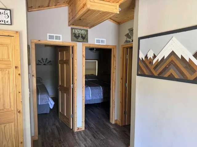 a view of a hallway with wooden floor and closet