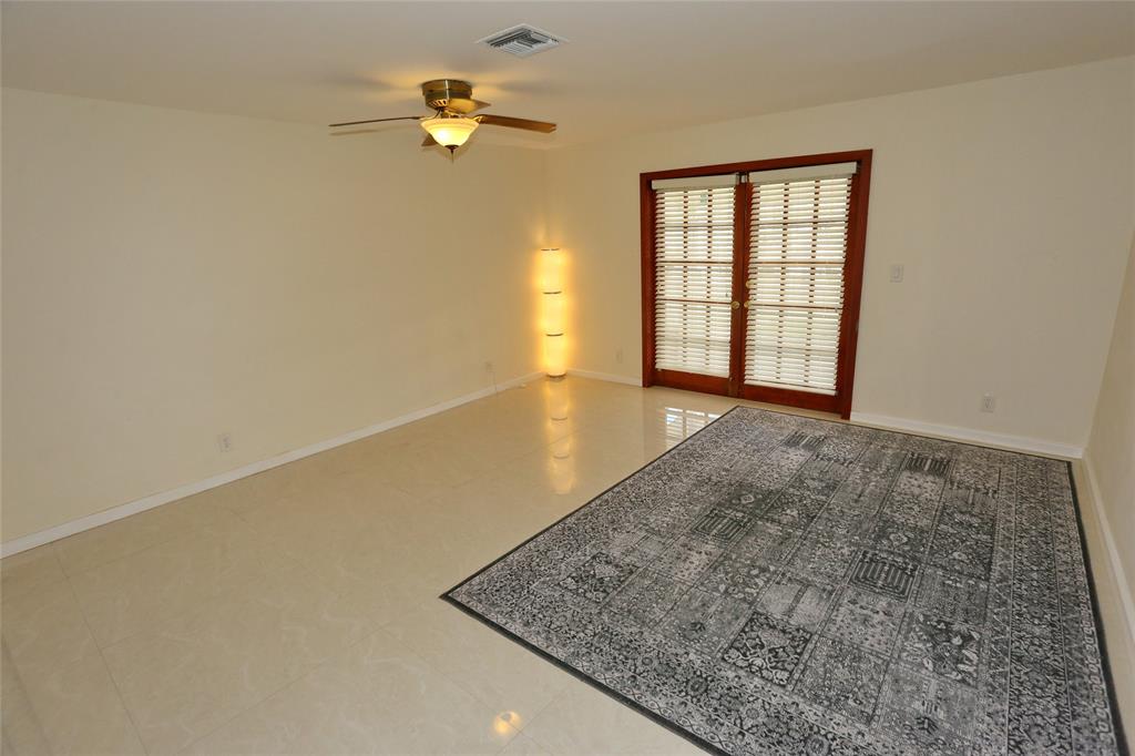 100 Circle Drive Pompano Beach, FL 33062 - Photo 12 of 30 an empty room with a window and ceiling fan