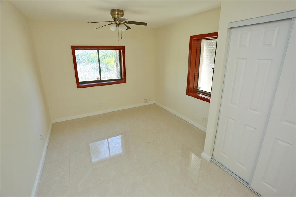 100 Circle Drive Pompano Beach, FL 33062 - Photo 14 of 30 an empty room with windows
