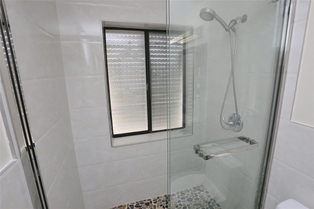 100 Circle Drive Pompano Beach, FL 33062 - Photo 16 of 30 a bathroom with a shower