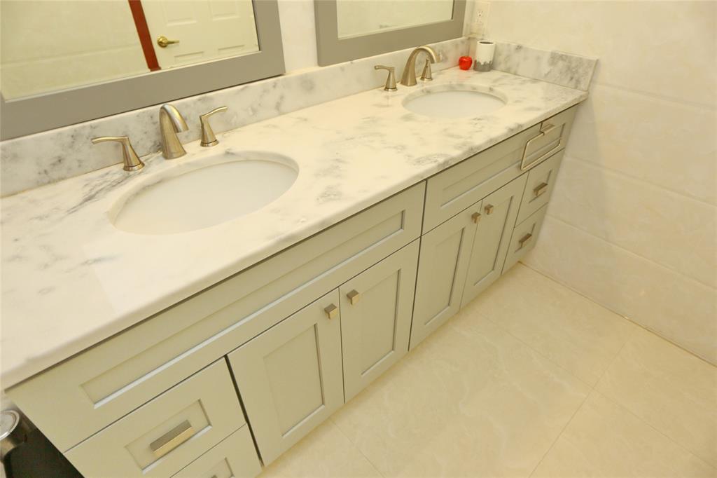 100 Circle Drive Pompano Beach, FL 33062 - Photo 18 of 30 a bathroom with a granite countertop sink and a mirror