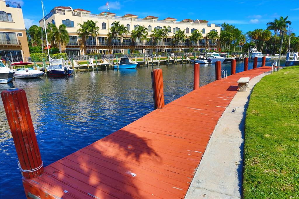 100 Circle Drive Pompano Beach, FL 33062 - Photo 2 of 30 a view of swimming pool with outdoor seating and lake view