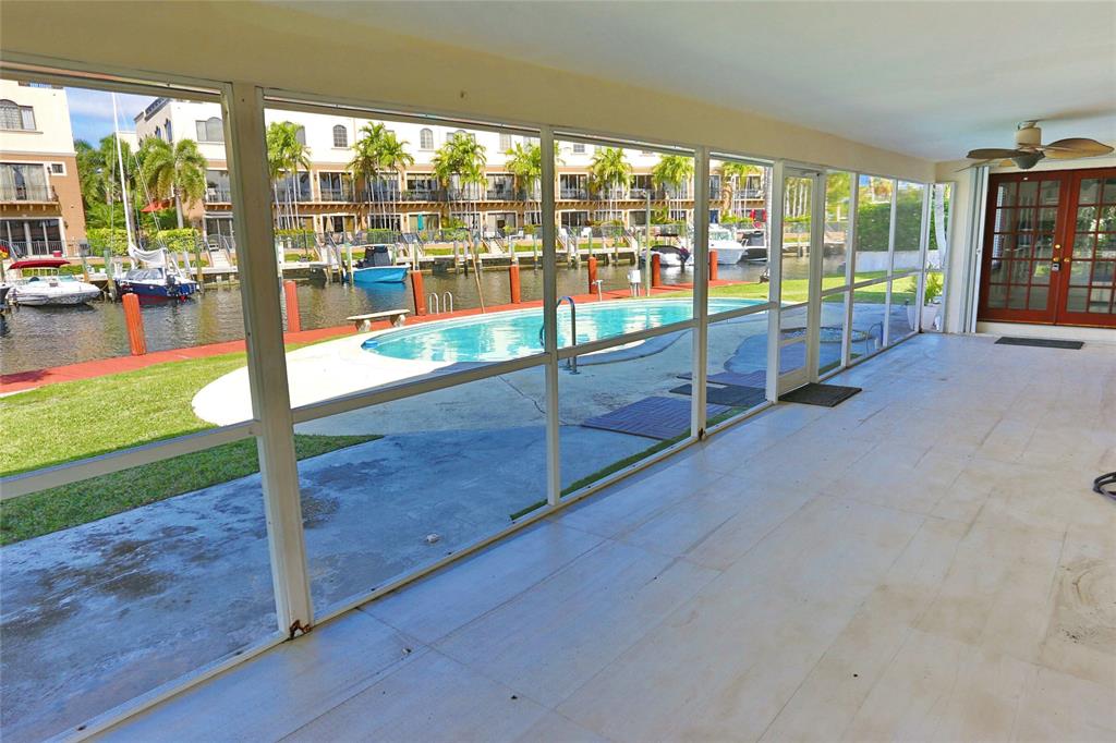 100 Circle Drive Pompano Beach, FL 33062 - Photo 21 of 30 an empty room with floor to ceiling windows and yard
