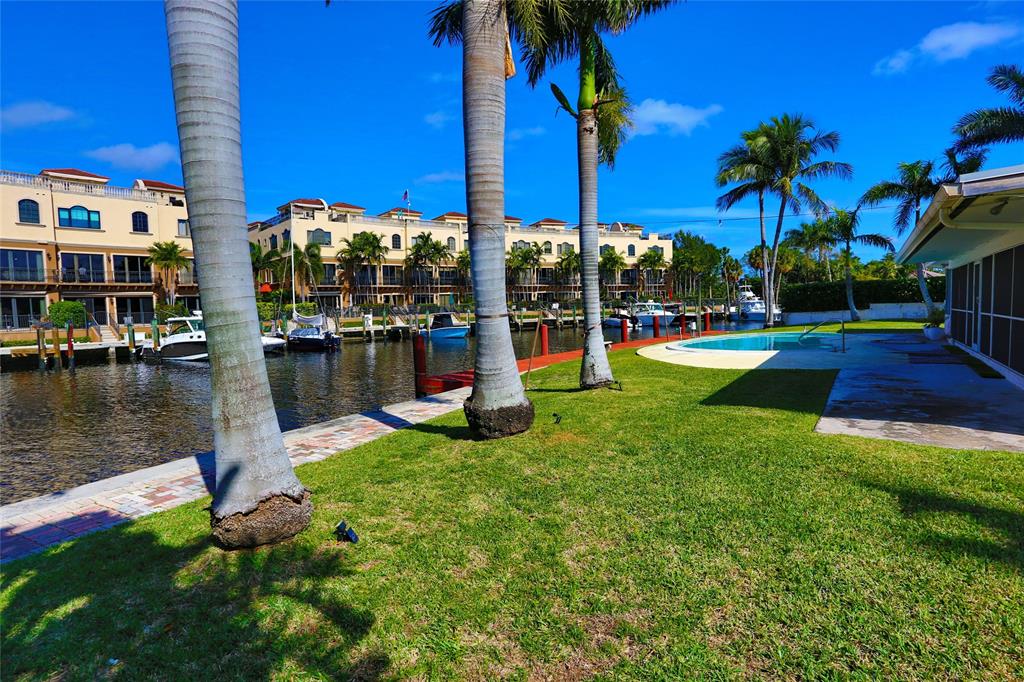 100 Circle Drive Pompano Beach, FL 33062 - Photo 28 of 30 a view of a house with swimming pool and sitting area