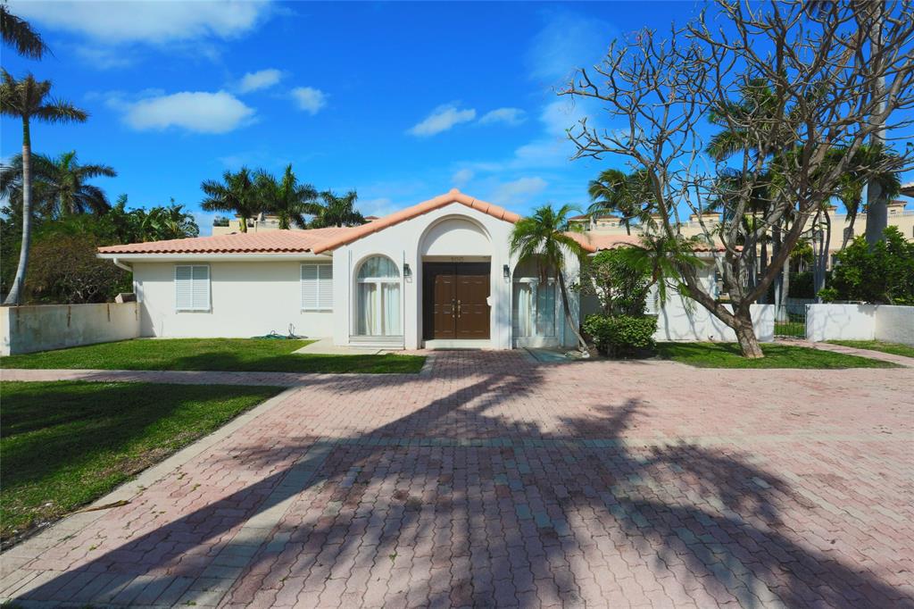 100 Circle Drive Pompano Beach, FL 33062 - Photo 4 of 30 a front view of a house with a yard and garage