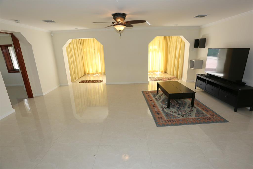 100 Circle Drive Pompano Beach, FL 33062 - Photo 5 of 30 a living room with furniture and a chandelier