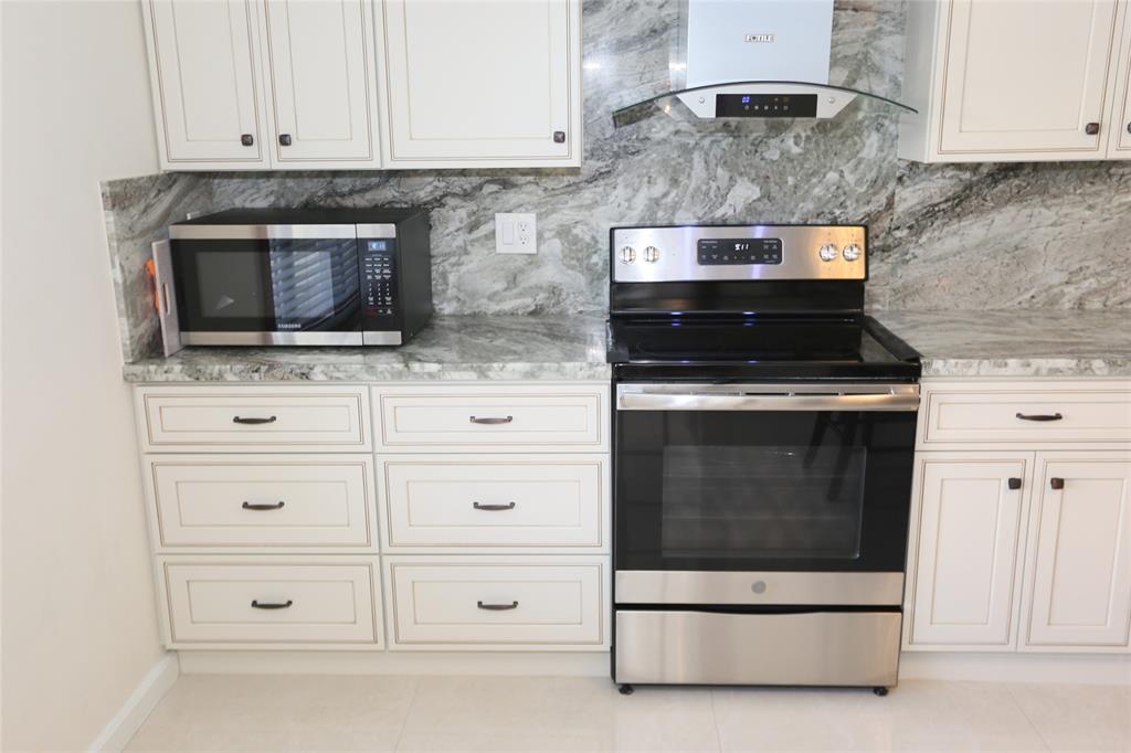 100 Circle Drive Pompano Beach, FL 33062 - Photo 8 of 30 a stove top oven sitting inside of a kitchen