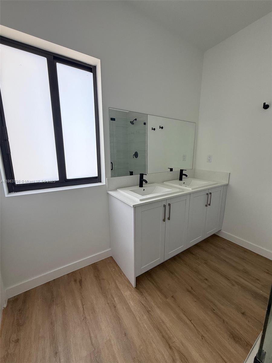 416 Southwest 1st Street, Unit 416 Florida City, FL 33034 - Photo 16 of 24 a utility room with a sink a mirror and a window