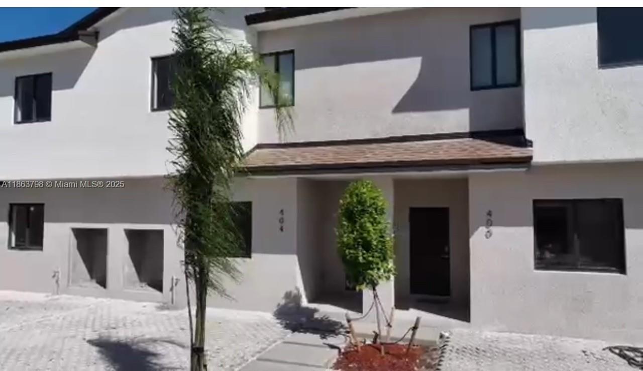 416 Southwest 1st Street, Unit 416 Florida City, FL 33034 - Photo 9 of 24 a front view of a house with garden