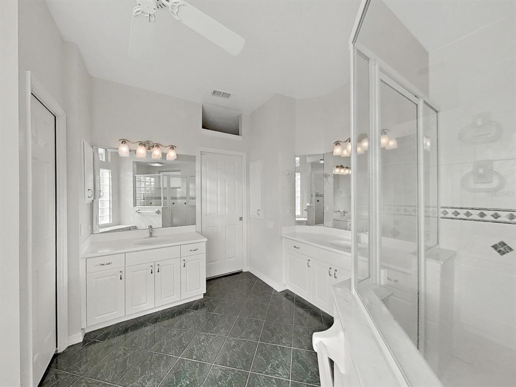 14595 Oliver Street Largo, FL 33774 - Photo 17 of 35 a bathroom with a double vanity sink toilet and shower
