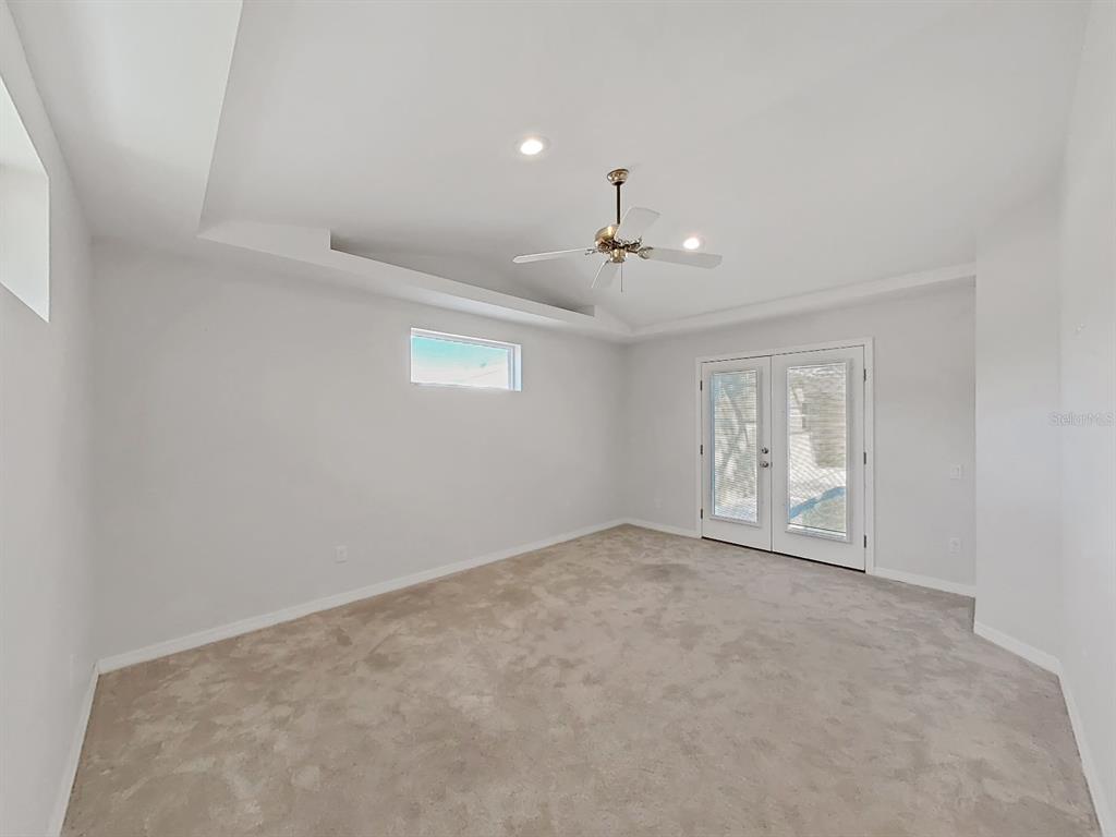14595 Oliver Street Largo, FL 33774 - Photo 18 of 35 a view of an empty room with a chandelier fan