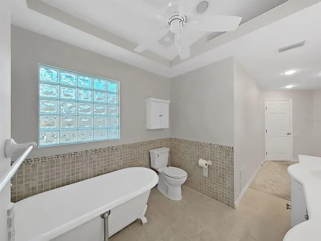 a bathroom with a bathtub and a toilet