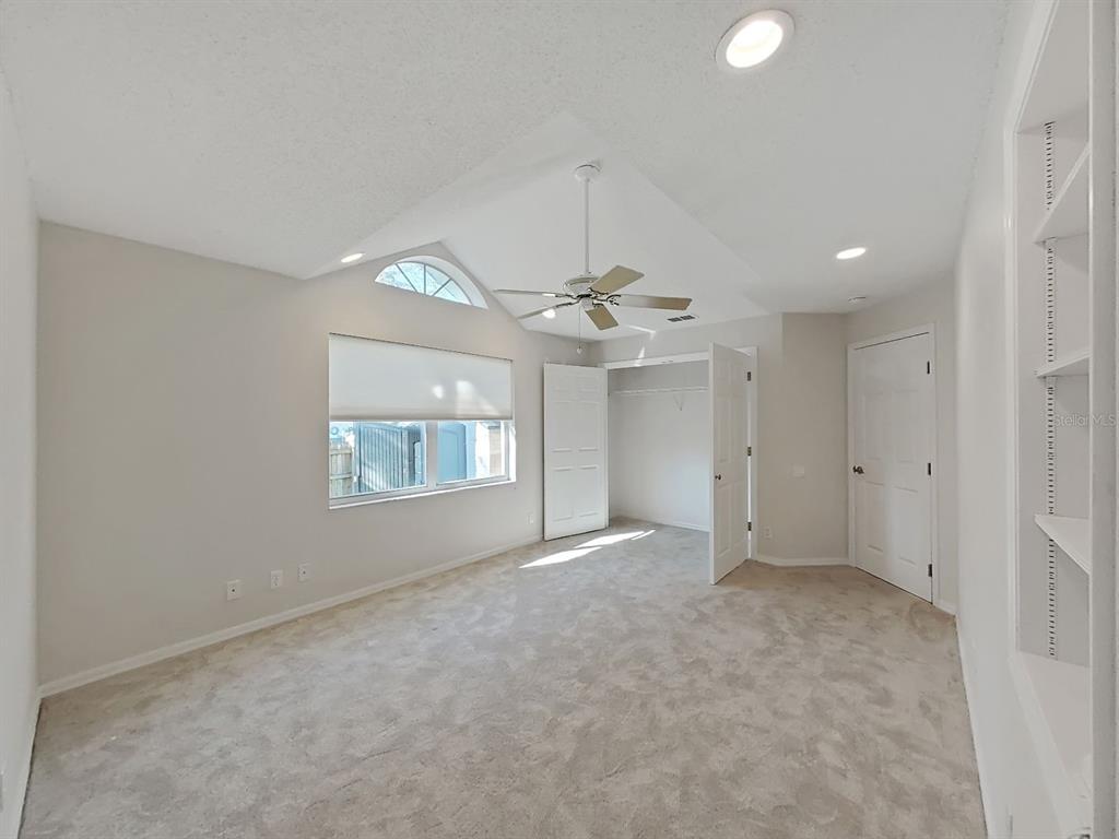 14595 Oliver Street Largo, FL 33774 - Photo 22 of 35 an empty room with a ceiling fan and a window