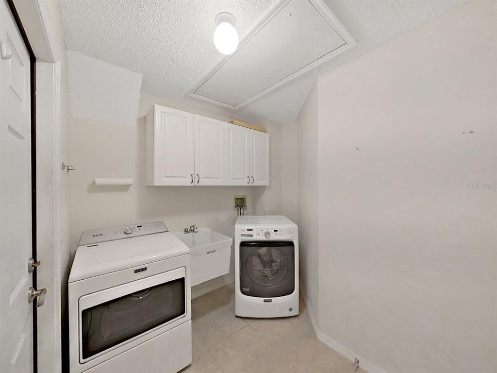 14595 Oliver Street Largo, FL 33774 - Photo 24 of 35 a utility room with dryer and washer