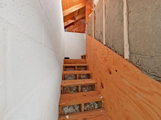 a view of stairs and wooden floor