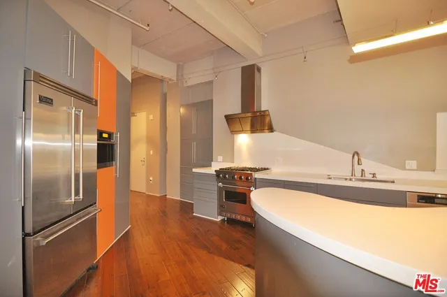 a kitchen with a refrigerator sink and stainless steel appliances
