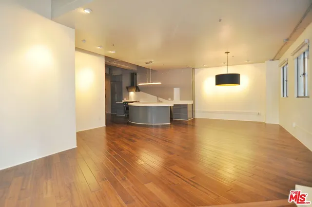 a view of kitchen and hall with wooden floor