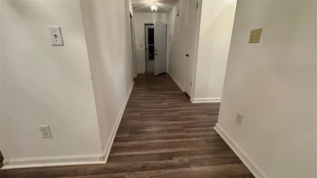 a view of a hallway with wooden floor and entryway