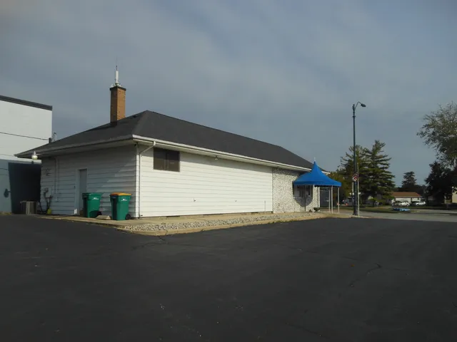 a front view of a house with a street