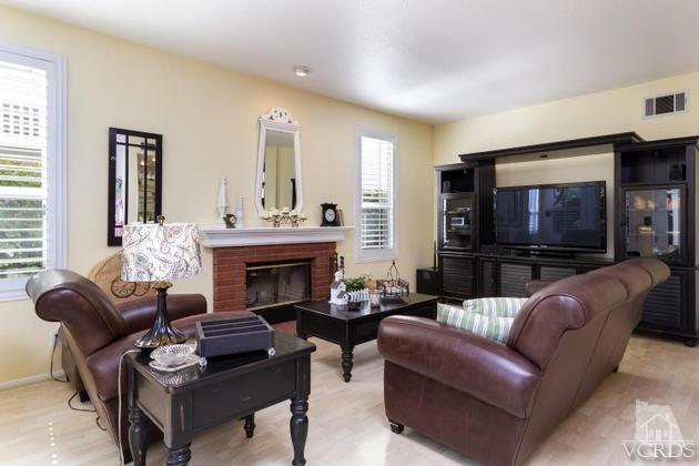 4349 Clearwood Road Moorpark, CA 93021 - Photo 12 of 35 a living room with furniture a flat screen tv and a fireplace