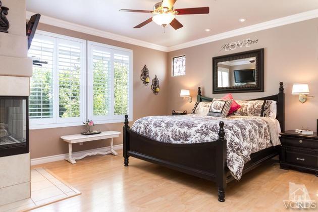 4349 Clearwood Road Moorpark, CA 93021 - Photo 13 of 35 a bedroom with a bed and a chandelier