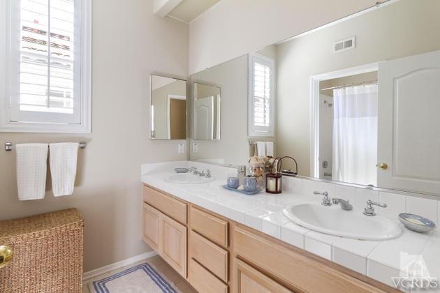 4349 Clearwood Road Moorpark, CA 93021 - Photo 19 of 35 a bathroom with double vanity sinks and a mirror