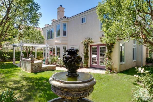 4349 Clearwood Road Moorpark, CA 93021 - Photo 33 of 35 a front view of a house with garden fountain and large tree