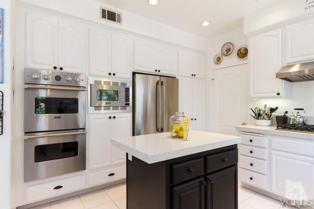 4349 Clearwood Road Moorpark, CA 93021 - Photo 10 of 35 a kitchen with cabinets and stainless steel appliances